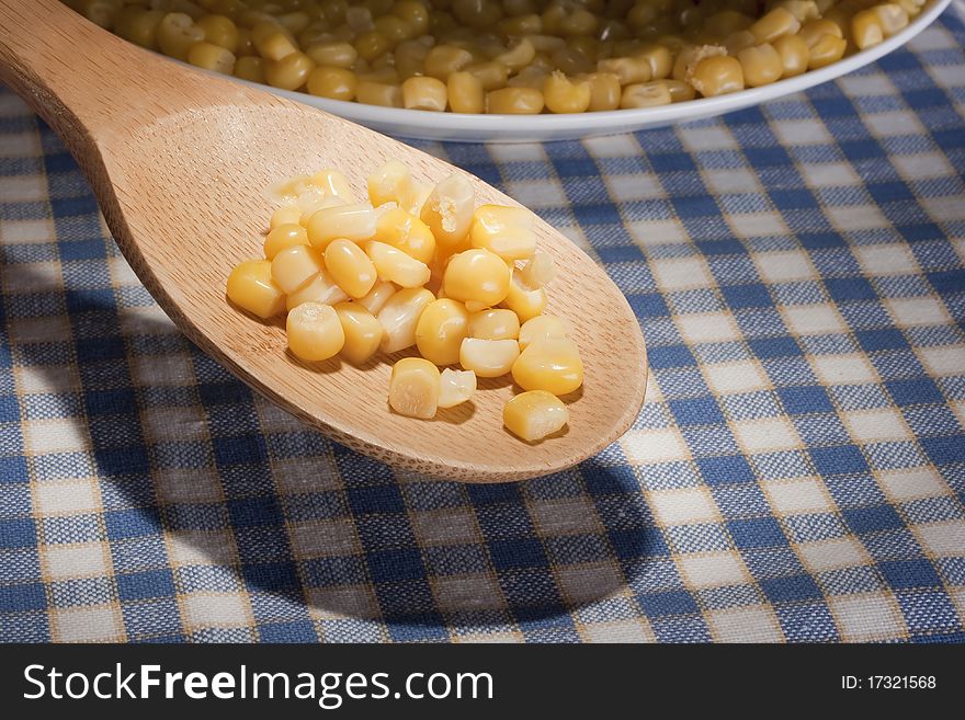 Canned corn in a wooden spoon chef.