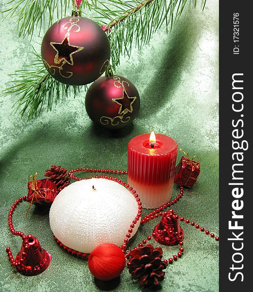 Two red ornamented with gold stars christmas balls scented candles on green background. Two red ornamented with gold stars christmas balls scented candles on green background