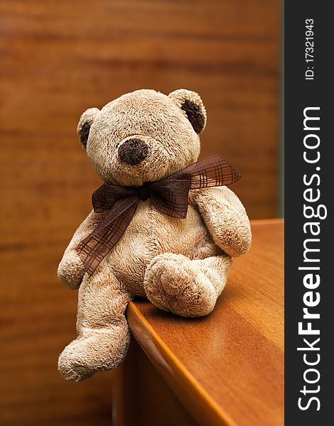 Teddy bears sitting on the edge of the chest of drawers