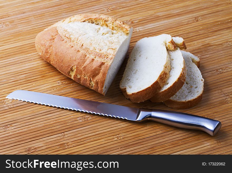 The bread cut by slices and knife for bread