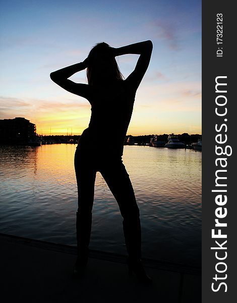 A woman in silhouette during a beautiful sunset. A woman in silhouette during a beautiful sunset