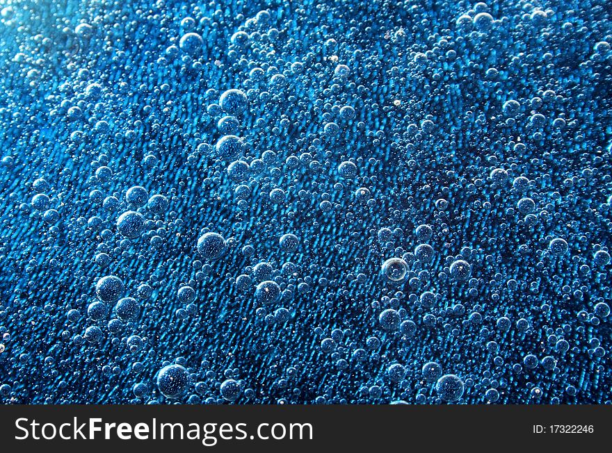 A series of bubbles under blue water. A series of bubbles under blue water