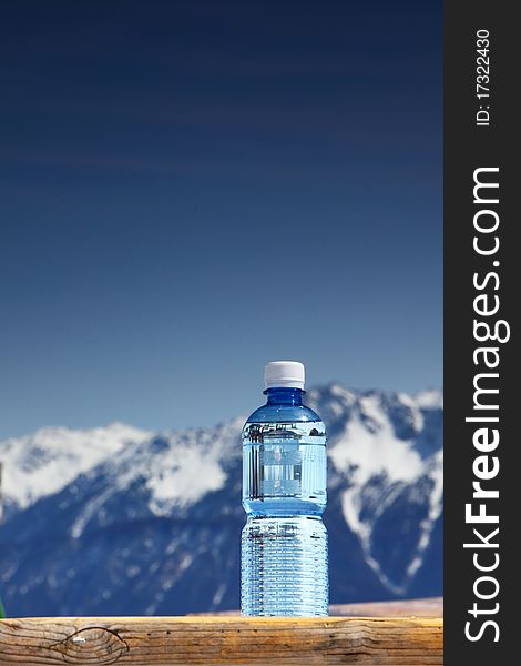 Water in cup mountains on background. Water in cup mountains on background