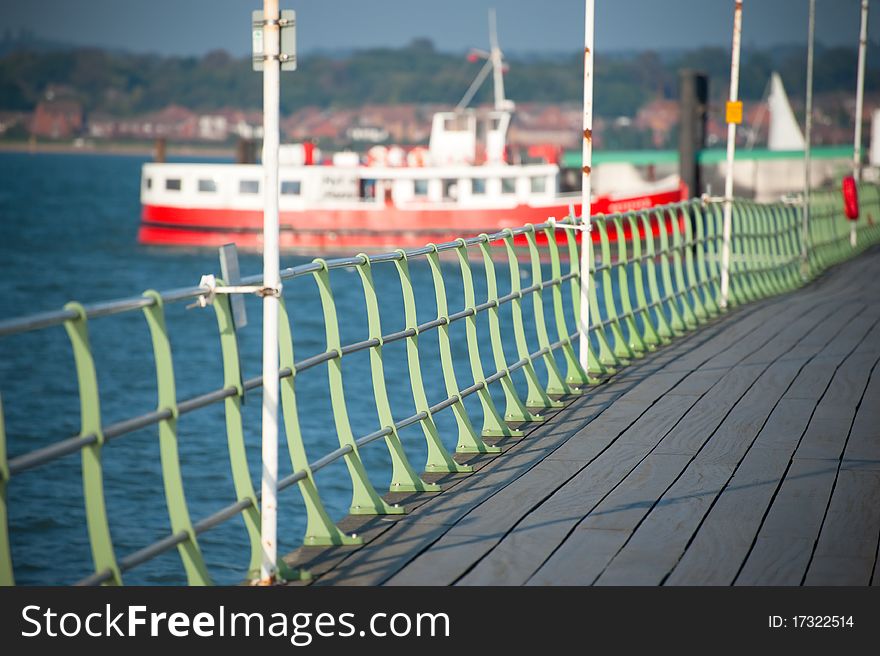 Boardwalk railings leading to docked ferryboat