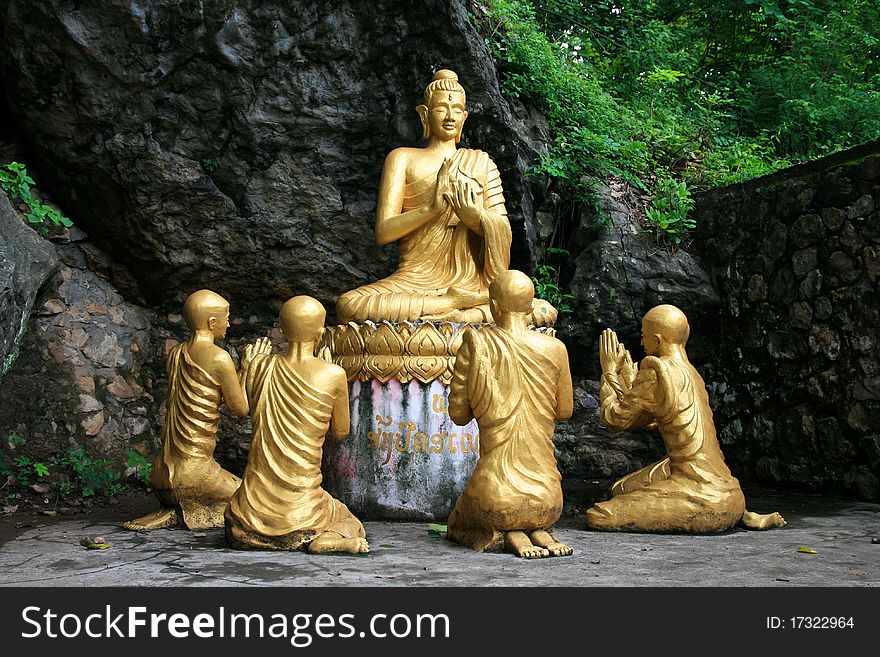 Gold sitting buddha surrounded by monk statues,Phou Si Hill, Luang Prabang, Laos, Asia. Gold sitting buddha surrounded by monk statues,Phou Si Hill, Luang Prabang, Laos, Asia