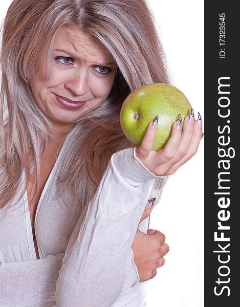 The lovely girl holds a green apple on a white background. The lovely girl holds a green apple on a white background