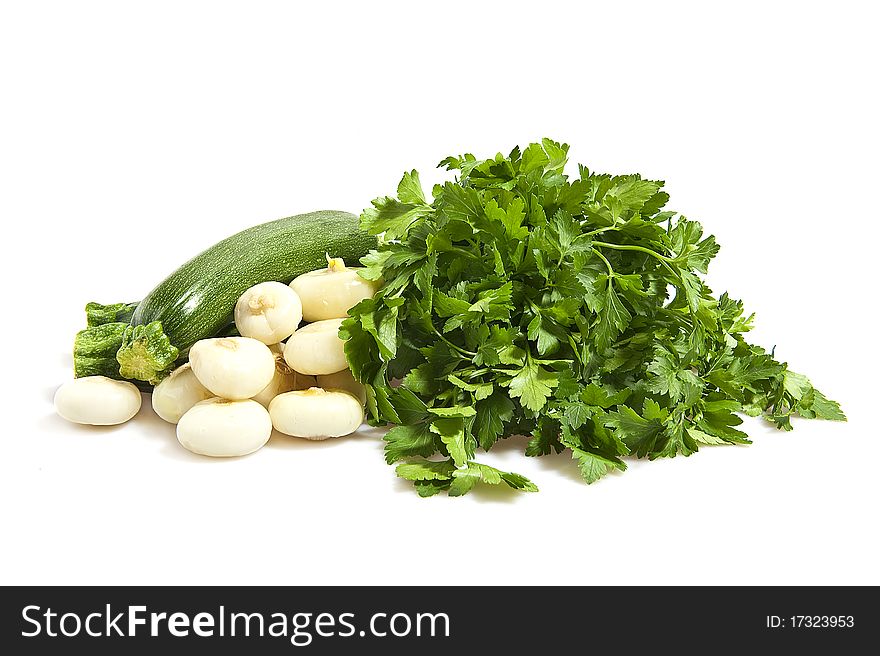 Zucchini, onions and parsley on a white background