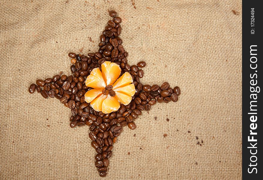 Fragrant fried coffee beans as a star with tangerine. Fragrant fried coffee beans as a star with tangerine