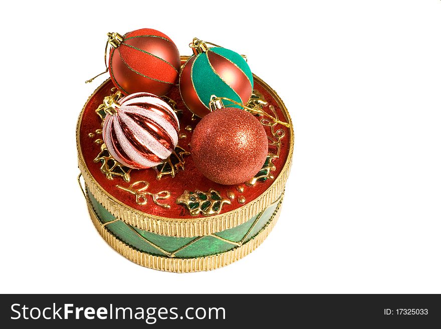 Ball shaped christmas ornaments on a decorative round box. Ball shaped christmas ornaments on a decorative round box