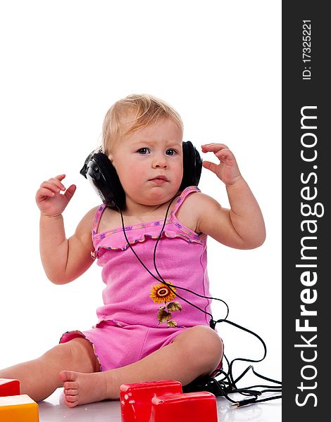 Baby with headphones, isolated on a white background