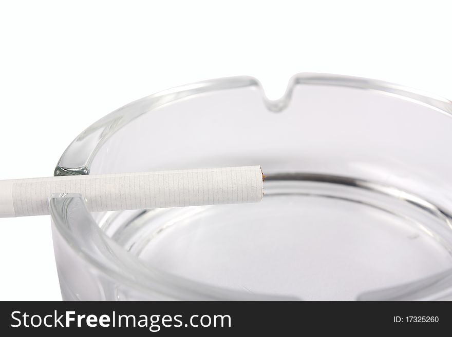 Ashtray with cigarette close-up isolated on white background. Ashtray with cigarette close-up isolated on white background