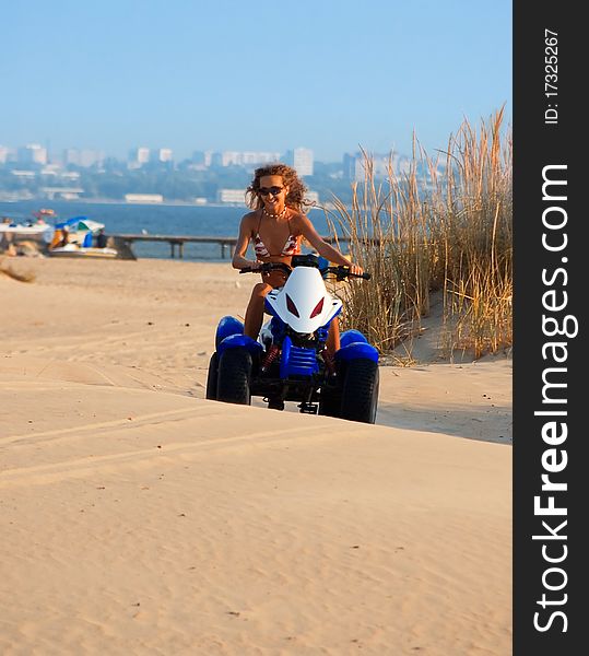 Woman on motobike on beach