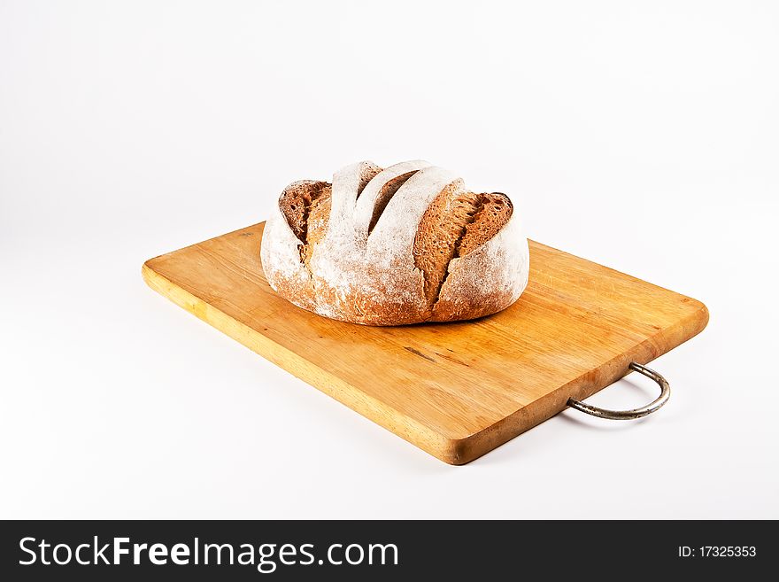 Homemade white bread lying on cutting board