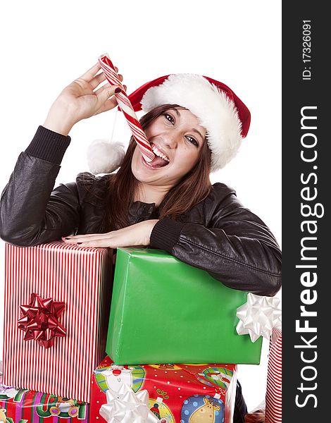 A woman is leaning on a stack of presents licking a peppermint stick. A woman is leaning on a stack of presents licking a peppermint stick.