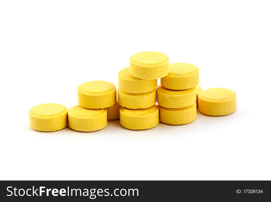 Yelow pills isolated on white