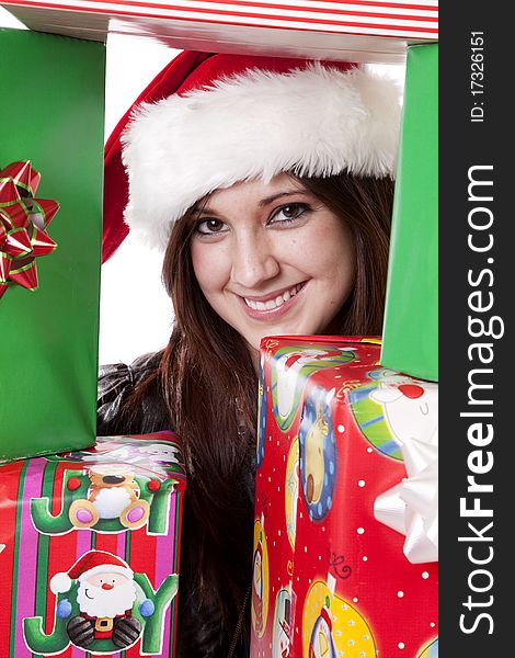 A woman is looking through a stack of presents. A woman is looking through a stack of presents