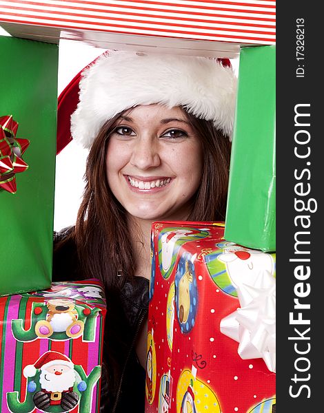 A woman is peeking through a stack of presents. A woman is peeking through a stack of presents