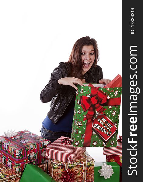 A woman is by a stack of presents and very excited. A woman is by a stack of presents and very excited.