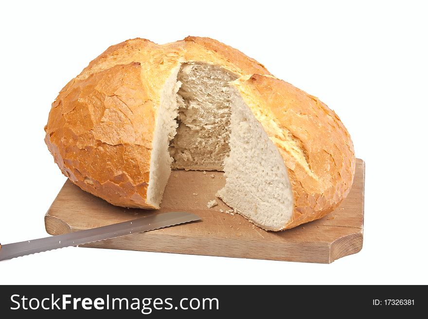 Round bread on wooden cutting board isolated on white