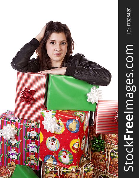 A woman is leaning on a stack of presents with a serious expression. A woman is leaning on a stack of presents with a serious expression