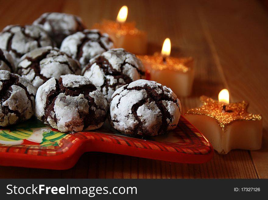 Chocolate crinkles on a background with candles