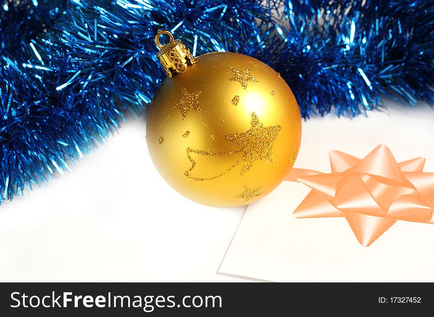 Golden Christmas bauble and  blue tinsel. Golden Christmas bauble and  blue tinsel
