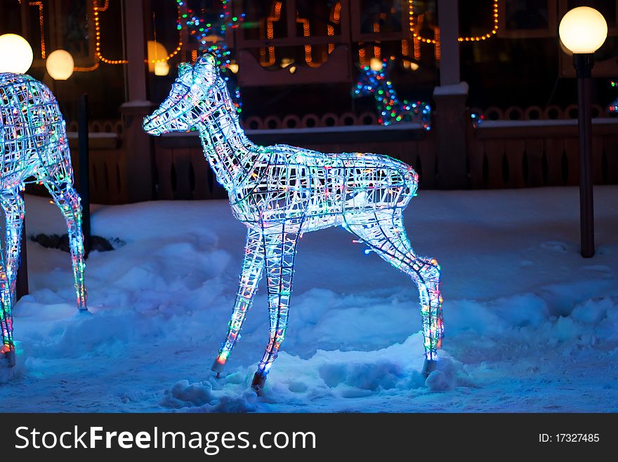 Glowing reindeer made of wire and color light bulbs. Glowing reindeer made of wire and color light bulbs