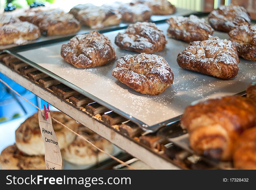 Flaky almond croissant with powdered sugar