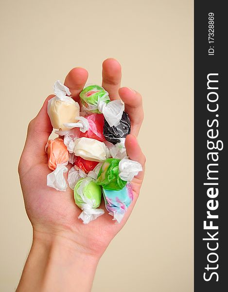 A pile of multicolored saltwater taffy candy on a white cloth.