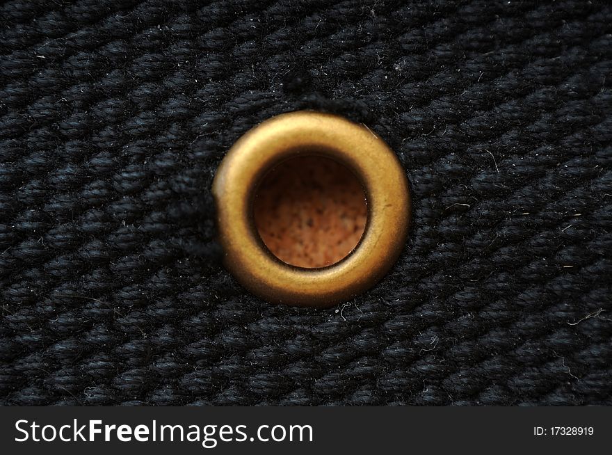 This is a black belt made from frabric with a brass metal o ring. This is a black belt made from frabric with a brass metal o ring