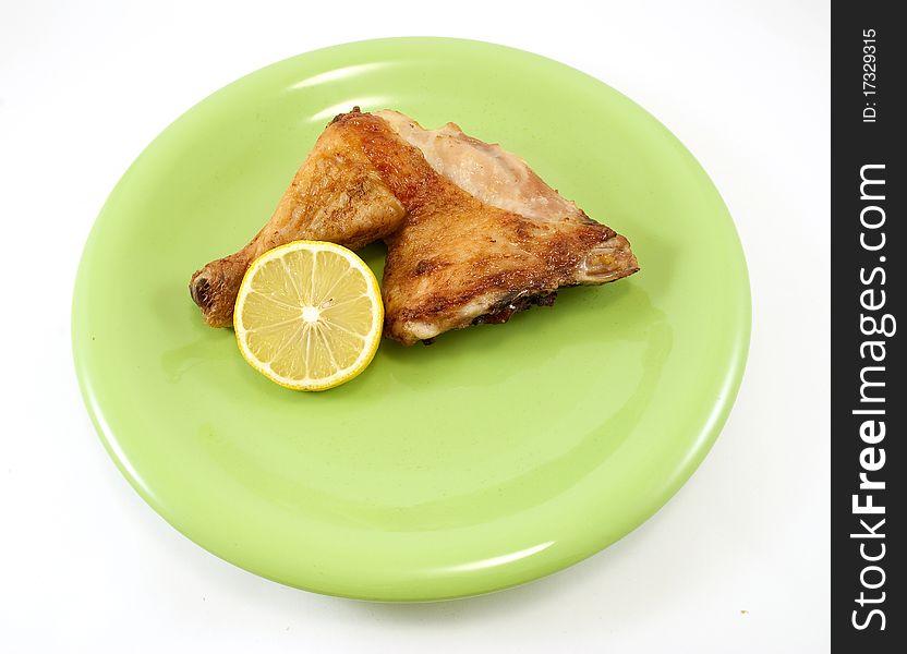 Chicken leg on green plate. Chicken leg on green plate