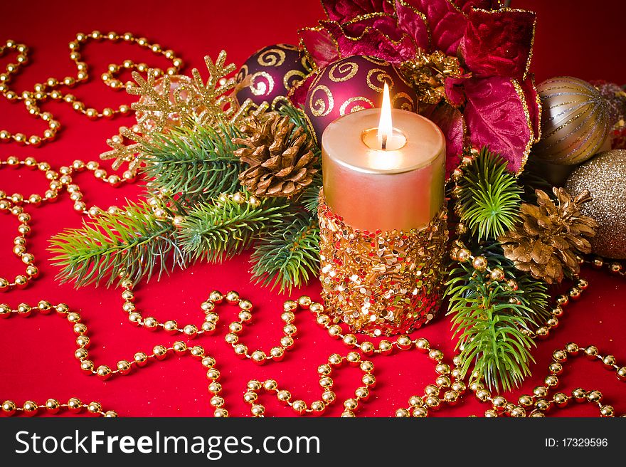 Burning gold candle amongst green fir branches,  Christmas concept. Burning gold candle amongst green fir branches,  Christmas concept