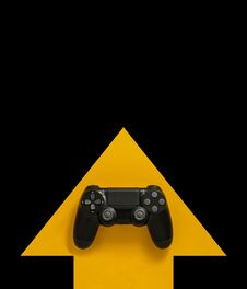 Modern Black Gamepad On A Yellow Arrow On A Black Background. Joystick On A Yellow Direction Indicator On A Dark Background. Flat Royalty Free Stock Images