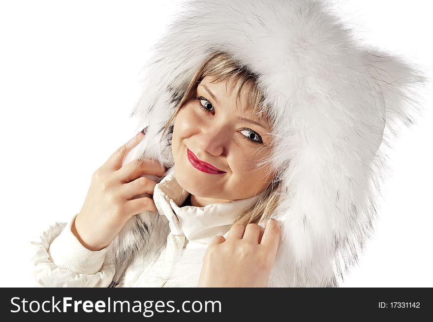 Portrait of the girl in a winter fluffy cap. Isolated on white