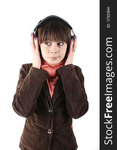 Closeup portrait of a young woman in a brown coat listening to music isolated on white background