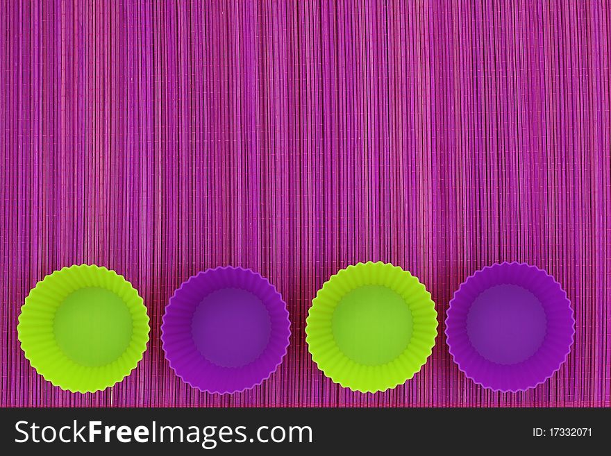 Colorful silicone baking cups on purple background