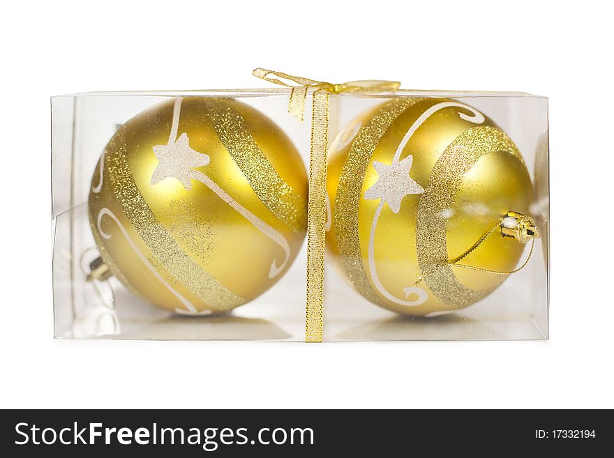 Two Christmas golden balls in transparent box isolated on white background