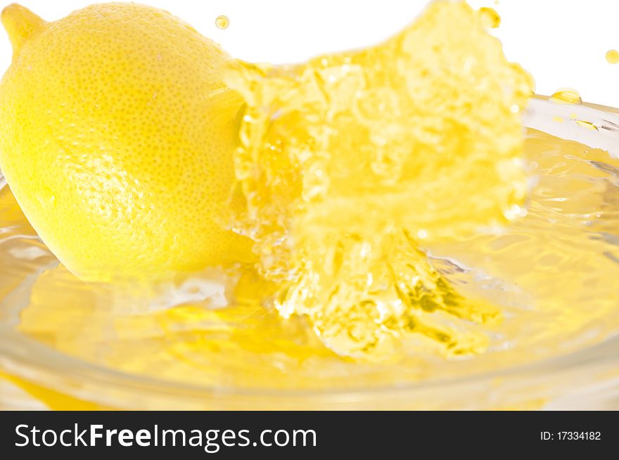 Lemon  falls into the juice. Lemon  falls into the juice