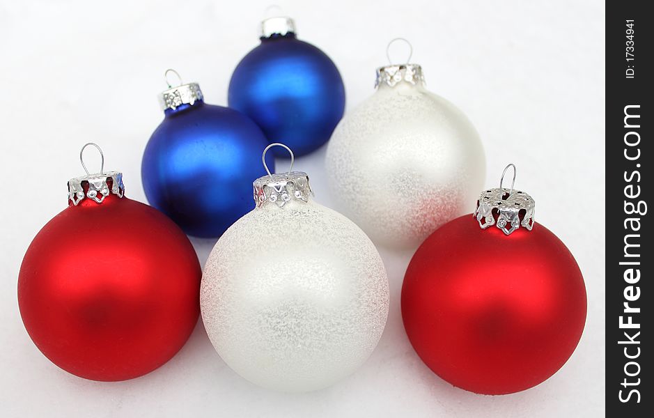 Christmas ball, blue red white lie in the snow. Christmas ball, blue red white lie in the snow