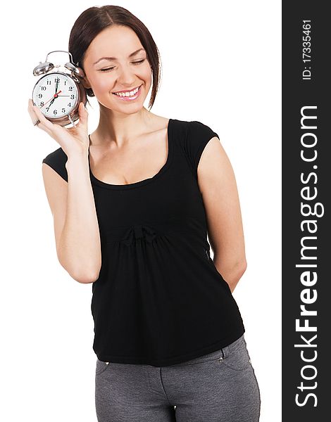 Cheerful young woman listening to the ticking of alarm clock. Cheerful young woman listening to the ticking of alarm clock