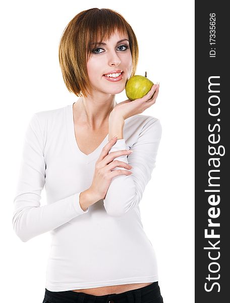 Portrait of a young beautiful woman with a green apple against white background