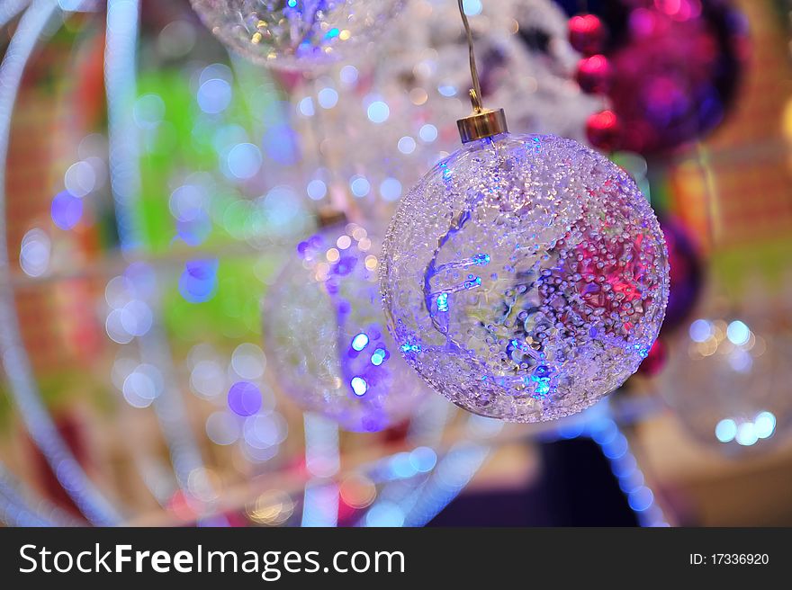 Glass Christmas balls with colourful bokeh background