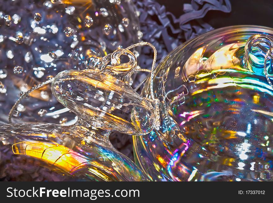 Three glass christmas balls with light reflections from the christams tree