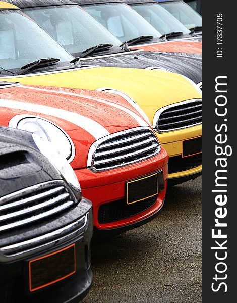 Cars lined up polished and clean on a wet day. Cars lined up polished and clean on a wet day