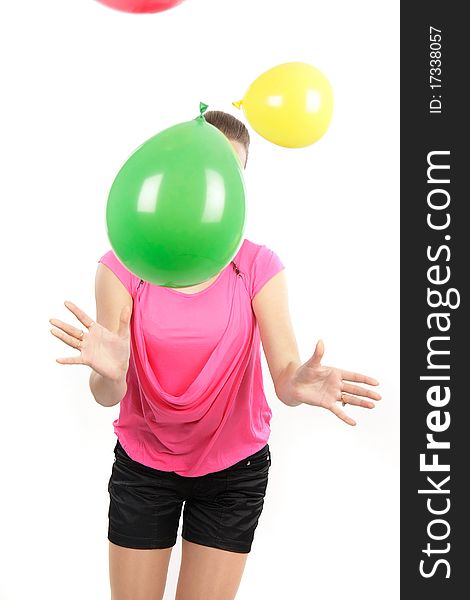 Young girl playing with balloons over white