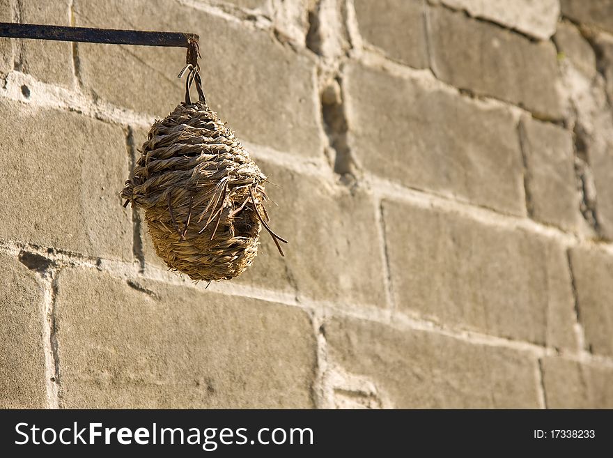 Bird feeder in front of the brick wall