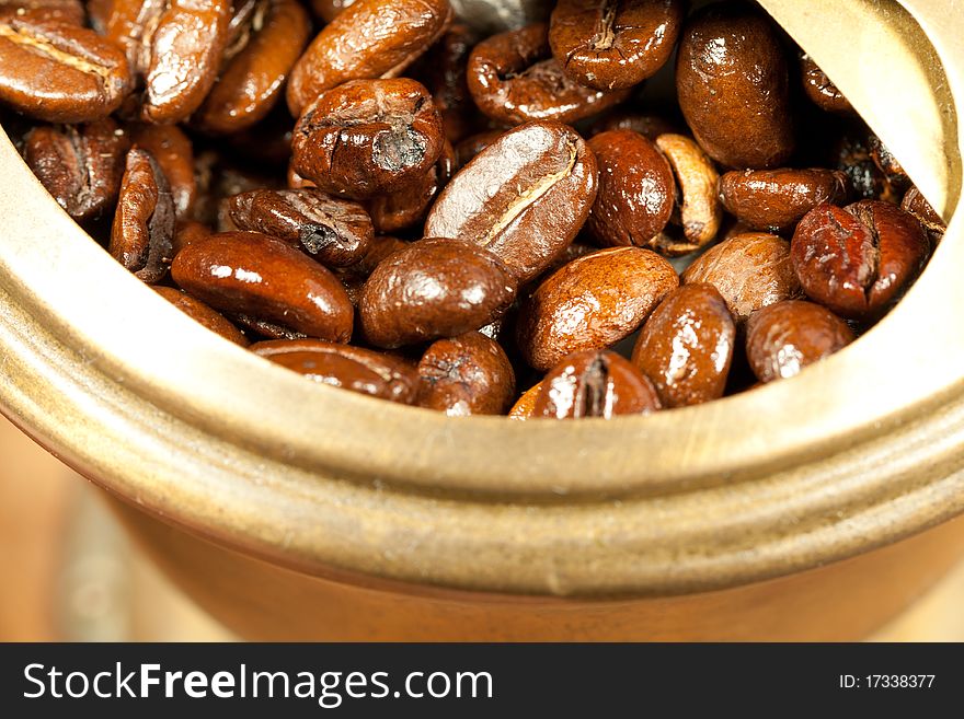 Fragrant fried coffee beans in the old coffee grinder. Fragrant fried coffee beans in the old coffee grinder