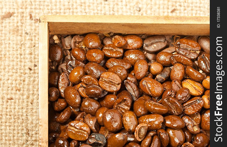 Fragrant fried coffee beans in the wooden box