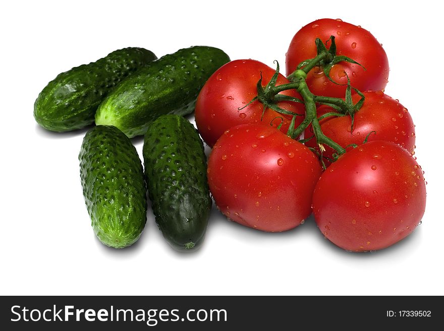 Ripe red tomatoes and cucumbers on a white background. Ripe red tomatoes and cucumbers on a white background