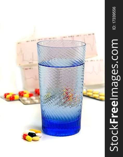 Different capsules with glass on white background